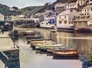 Historic waterfront buildings around the harbour river mouth of the River Pol at village of
