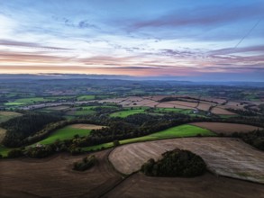 Sunset of Devon Farms and Fields over Berry Pomeroy from a drone, Totnes, England, United Kingdom
