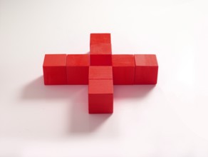 8 red wooden cubes against a white background