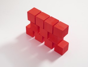11 red wooden cubes against a white background