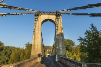 Suspension bridge of Coudes village on river Allier. Puy de Dome. Auvergne Rhone Alpes. France