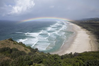 Tallow Beach bay with rainbow, lookout Byron Bay lighthouse, New South Wales, Australia