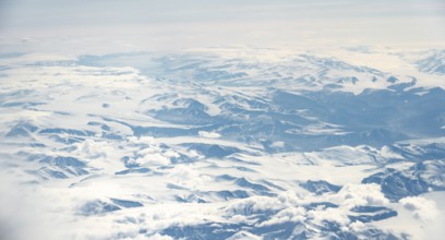 Icy, snowy arctic mountain landscape with glaciers, aerial view, Greenland, Arctic