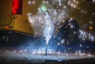 Burnt off fireworks are lying on the street, firecracker smoke produces smoke. New Year's night on