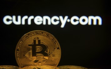 Dhaka, Bangladesh- 22 June 2025: Close-up of Bitcoin coins with the Currency.com logo visible on a