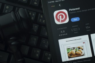 Dhaka, Bangladesh- 28 Oct 2025: An iPad displaying the Pinterest app against a judge's gavel and