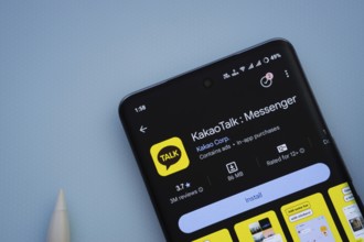 Dhaka, Bangladesh- 29 May 2025: On a blue surface, a smartphone displays the KakaoTalk app within