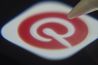 Dhaka, Bangladesh- 06 Dec 2025: Close-up of the Pinterest app on a screen with a stylus pointing at