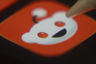 Dhaka, Bangladesh- 06 Dec 2025: Close-up of the Reddit app on a screen with a stylus pointing at it