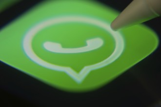 Dhaka, Bangladesh- 06 Dec 2025: Close-up of the WhatsApp app on a screen with a stylus pointing at