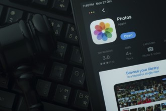 Dhaka, Bangladesh- 28 Oct 2025: An iPad displaying the Apple Photos app against a judge's gavel and