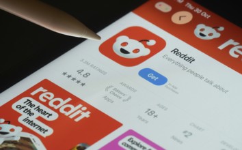 Dhaka, Bangladesh- 30 Oct 2025: Reddit app on a iPad screen with a pen pointing at the install