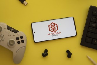 Dhaka, Bangladesh- 23 March 2025: Archosaur Games logo displayed on a smartphone surrounded by