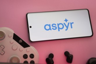 Dhaka, Bangladesh- 08 Apr 2025: A smartphone displaying the Aspyr logo next to a gaming controller