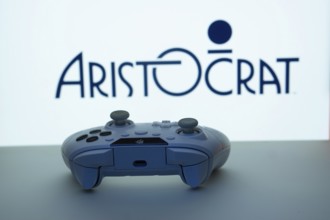 Dhaka, Bangladesh- 08 Apr 2025: A gaming controller in front of a Aristocrat screen