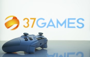 Dhaka, Bangladesh- 20 Mar 2025: A close-up of a white gamepad with the 37Games seen on screen in