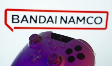 Dhaka, Bangladesh- 20 Mar 2025: A close-up of a gamepad with the Bandai Namco Entertainment seen on
