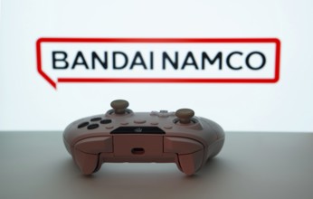 Dhaka, Bangladesh- 08 Apr 2025: A gaming controller in front of a Bandai Namco Entertainment screen