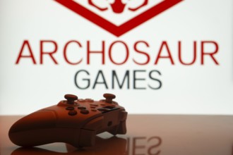 Dhaka, Bangladesh- 20 Mar 2025: A close-up of a white gamepad with the Archosaur Games seen on