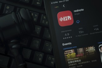 Dhaka, Bangladesh- 28 Oct 2025: An iPad displaying the rednote app against a judge's gavel and dark