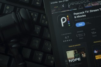 Dhaka, Bangladesh- 28 Oct 2025: An iPad displaying the Peacock TV app against a judge's gavel and