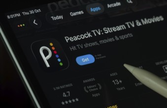 Dhaka, Bangladesh- 30 Oct 2025: Peacock TV app displayed on a iPad screen in dark mode with a