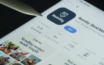 Dhaka, Bangladesh- 30 Oct 2025: Remitly app on a iPad screen with a pen pointing at the install