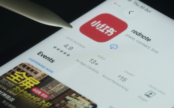 Dhaka, Bangladesh- 30 Oct 2025: rednote app on a iPad screen with a pen pointing at the install