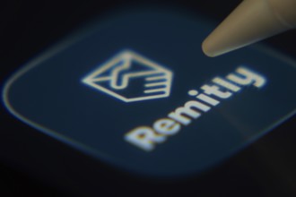 Dhaka, Bangladesh- 06 Dec 2025: Close-up of the Remitly app on a screen with a stylus pointing at