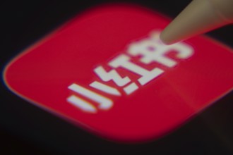 Dhaka, Bangladesh- 06 Dec 2025: Close-up of the rednote app on a screen with a stylus pointing at