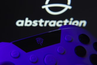 Dhaka, Bangladesh- 24 Mar 2025: A close-up of a gamepad with the Abstraction seen on screen in the