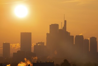 The sun rises behind Frankfurt's banking skyline, Frankfurt am Main, Hesse, Germany