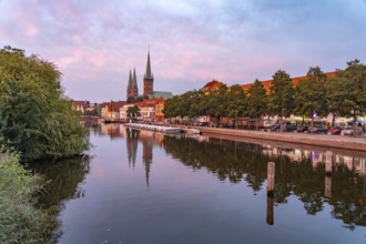 Old town with St. Mary's Church and St. Peter's Church and the Trave at dusk, Lübeck,