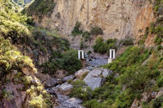 Small bridge over a rocky gorge surrounded by lush vegetation, The landscape of Colca Canyon in the