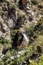 Suspension bridge that crosses a deep gorge between rocks, The landscape of the Colca Canyon in the