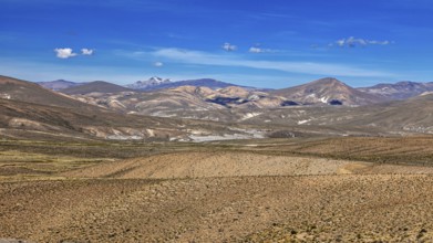 Pristine vast landscape with rolling desert under blue sky, The Andean highlands of Peru