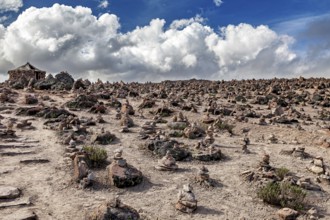 Barren hilly landscape with stone clusters under a cloudy sky, The Andean highlands of Peru