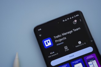 Dhaka, Bangladesh- 29 May 2025: On a blue surface, a smartphone displays the Trello app within the