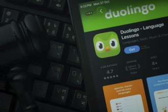 Dhaka, Bangladesh- 28 Oct 2025: An iPad displaying the Duolingo app against a judge's gavel and
