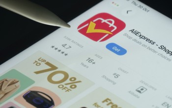 Dhaka, Bangladesh- 21 Nov 2025: AliExpress app on a iPad screen with a pen pointing at the install