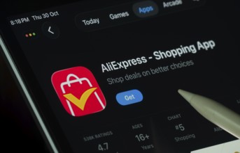 Dhaka, Bangladesh- 21 Nov 2025: AliExpress app displayed on a iPad screen in dark mode with a