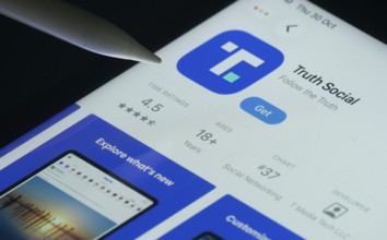 Dhaka, Bangladesh- 30 Oct 2025: Truth Social app on a iPad screen with a pen pointing at the