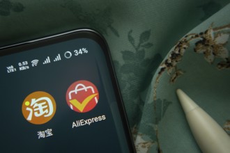 Dhaka, Bangladesh- 07 May 2025: Taobao and AliExpress app icon is seen on smartphone