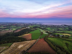 Sunset of Devon Farms and Fields over Berry Pomeroy from a drone, Totnes, England, United Kingdom