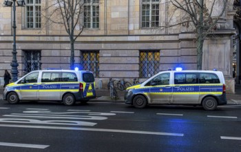 Police vehicles with flashing lights switched on, special operation at the Berlin State Library,