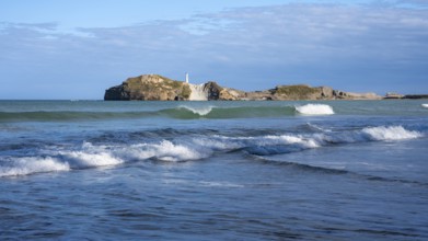 Castlepoint Beach and Castlepoint Lighthouse, ocean, waves, surf, sandy beach, rocks. Castlepoint,