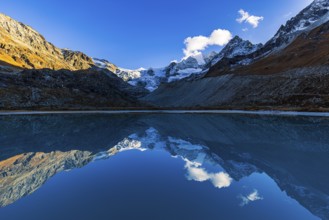 The Moiry glacier and mountain peaks are reflected in Lac de Chateaupre, Val d'Anniviers, Valais