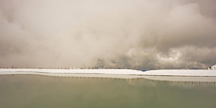 Another onset of winter in May, Riezler Alpsee, an artificially created lake, snow pond, feeds the