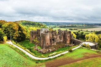 Autumn Colours over ruins of Goodrich Castle and River Wye from a drone, Goodrich, Herefordshire,