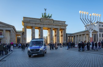 Large Hanukkah chandelier at the Brandenburg Gate in daylight, sign of lively Jewish life, symbolic